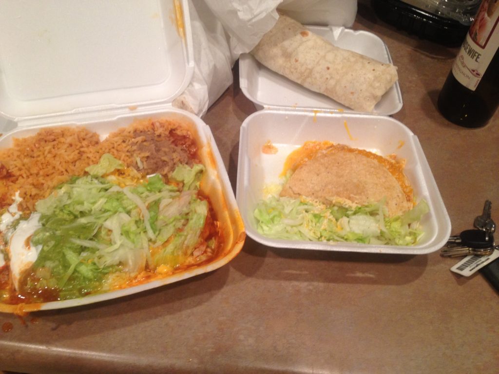 two take out containers with food in them