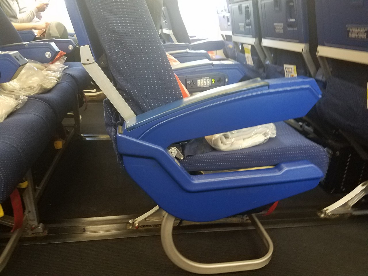 a blue seat with a leg on it