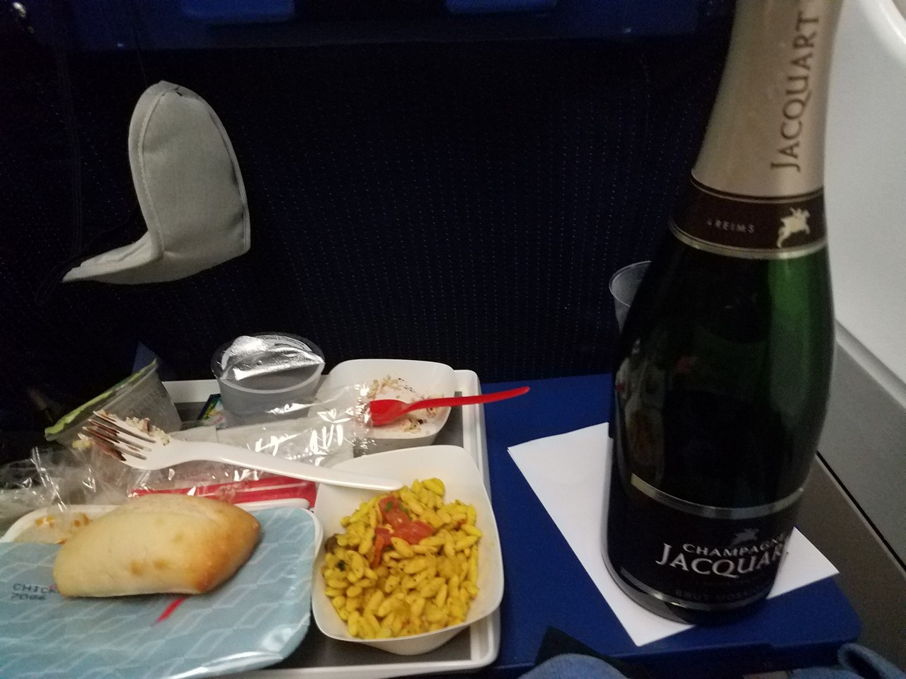 a bottle of champagne and food on a tray