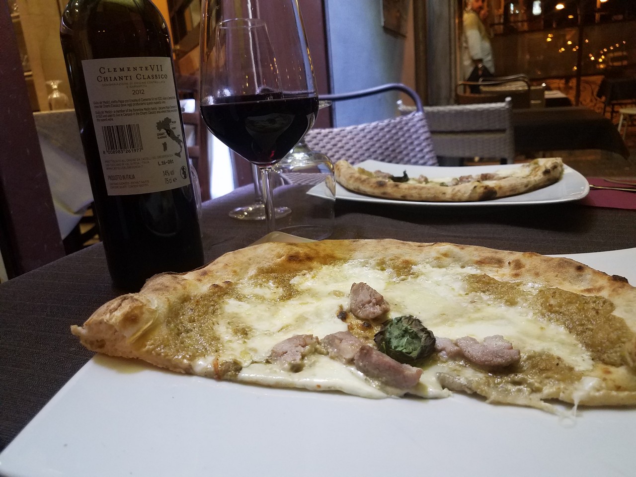 a pizza and wine on a table