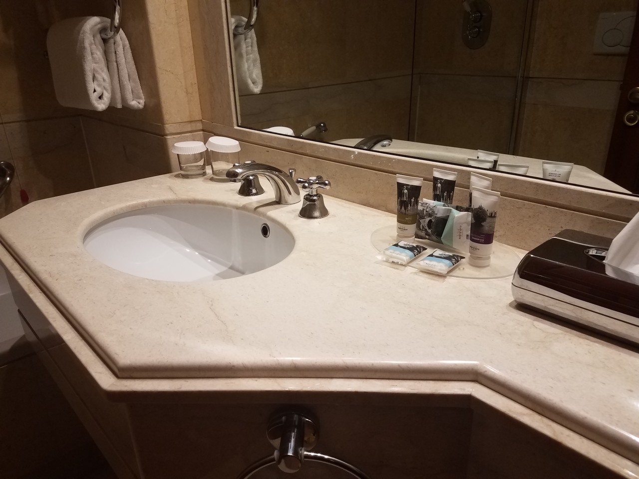 a bathroom sink with a mirror and a small toiletries