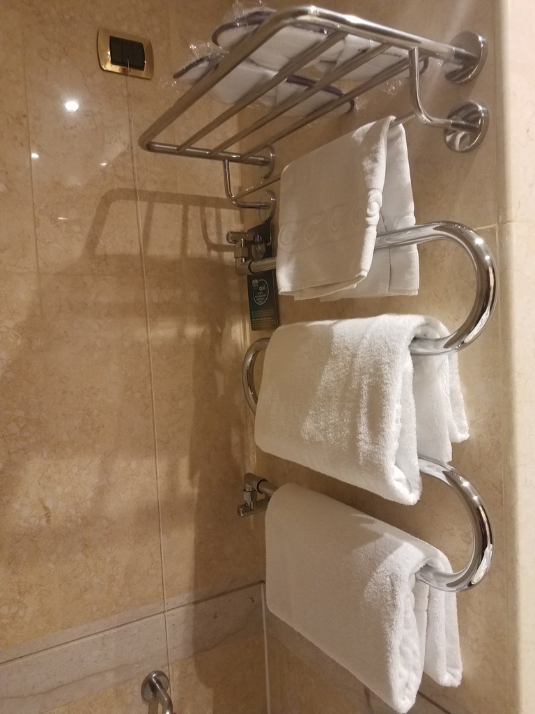 a towel rack with white towels on it