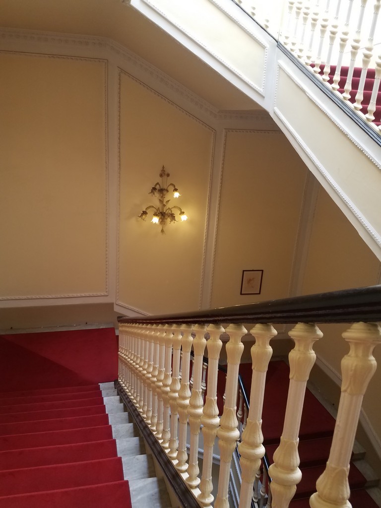 a staircase with red carpet and white railings