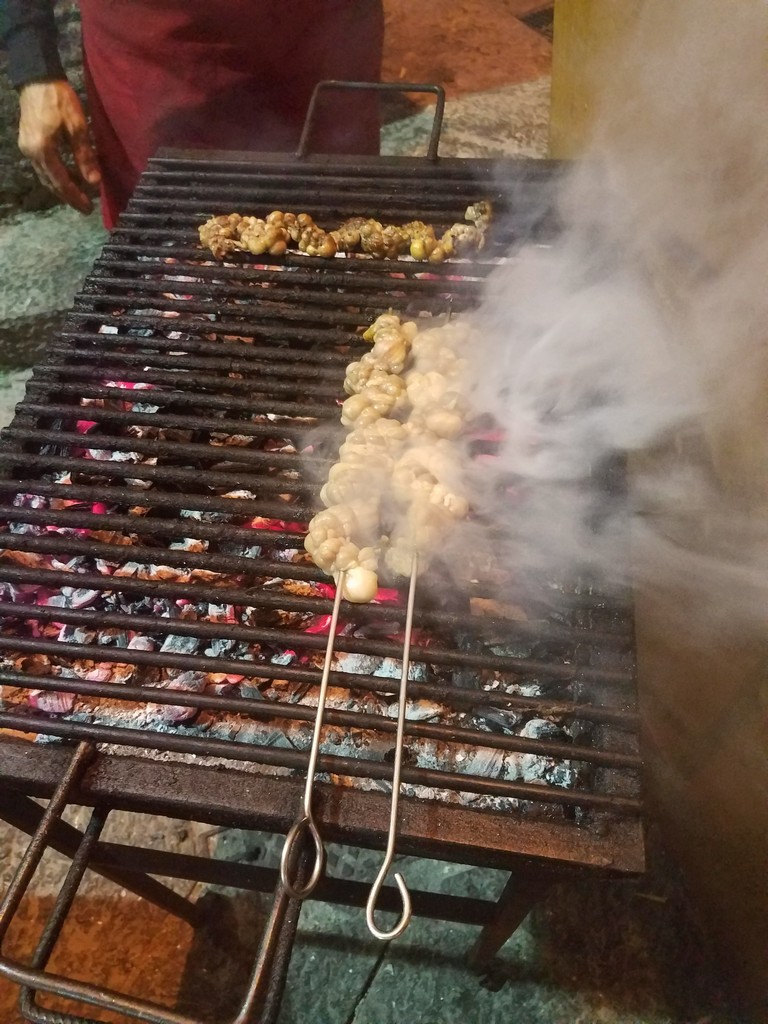 food on a grill with smoke