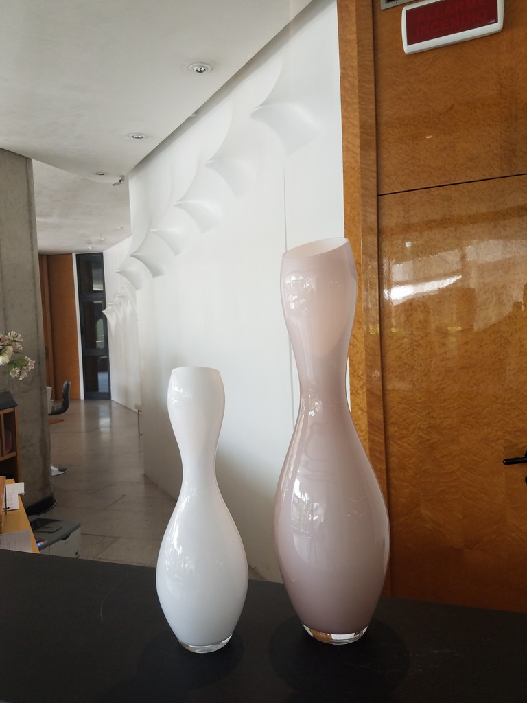 two white vases on a table