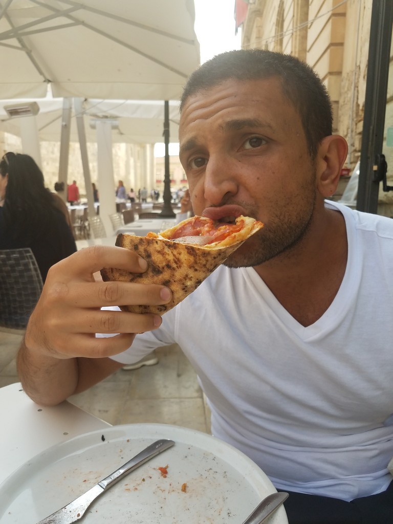 a man eating a pizza