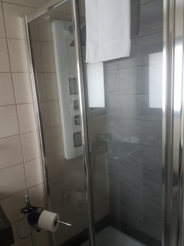 a glass shower door with a towel on it