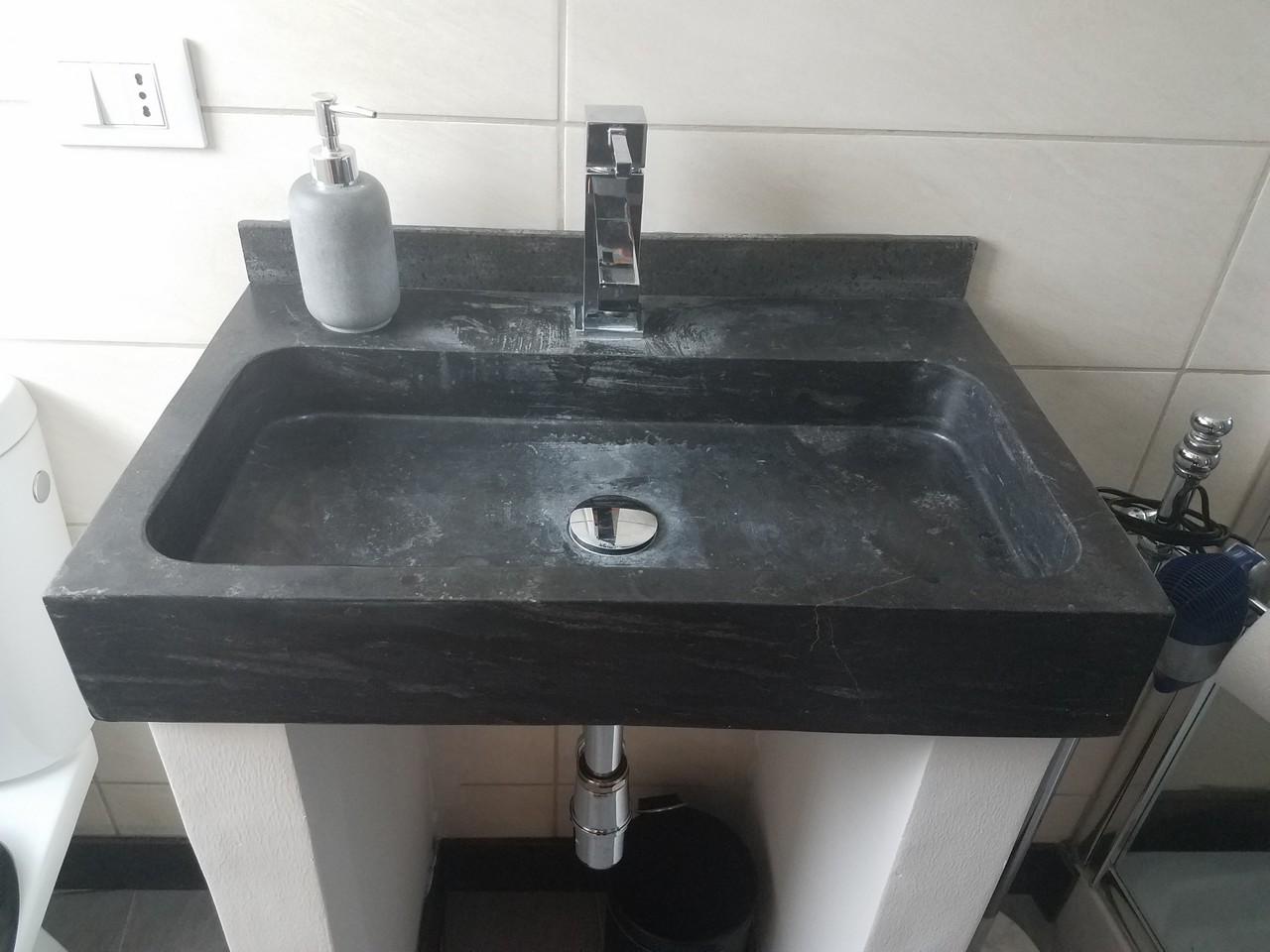 a sink with a soap dispenser