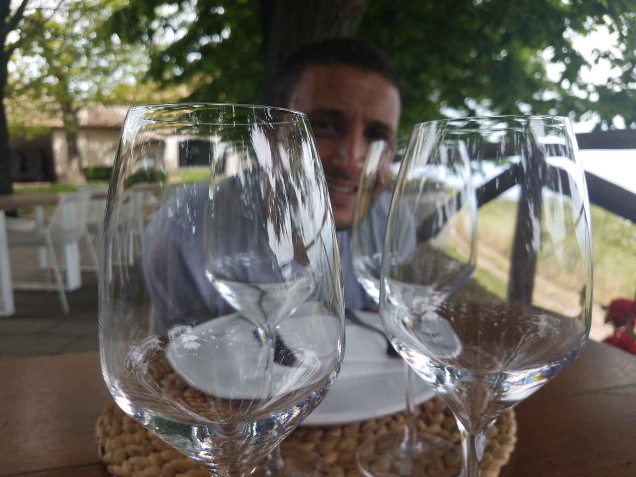 a man behind empty wine glasses