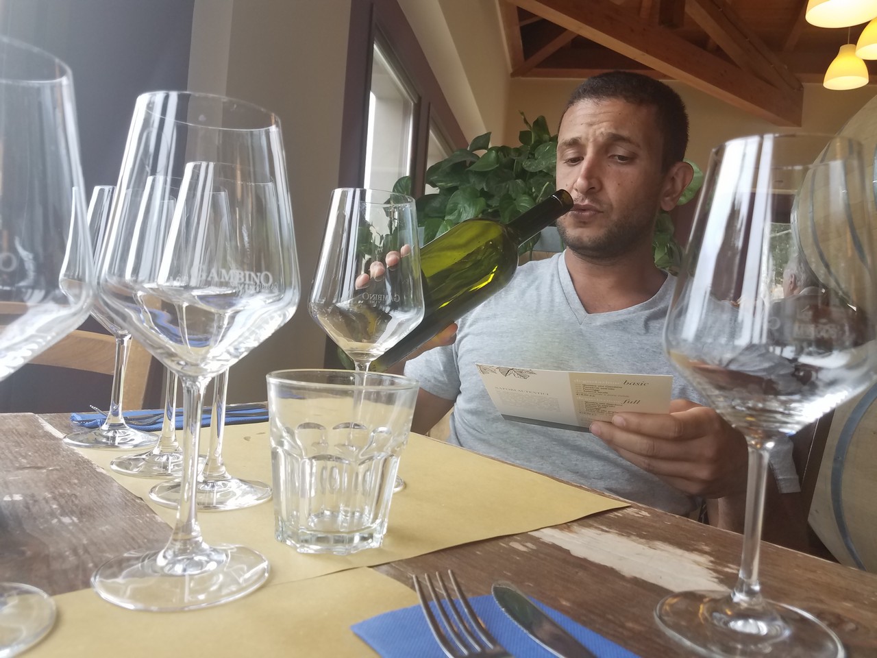a man drinking wine from a bottle