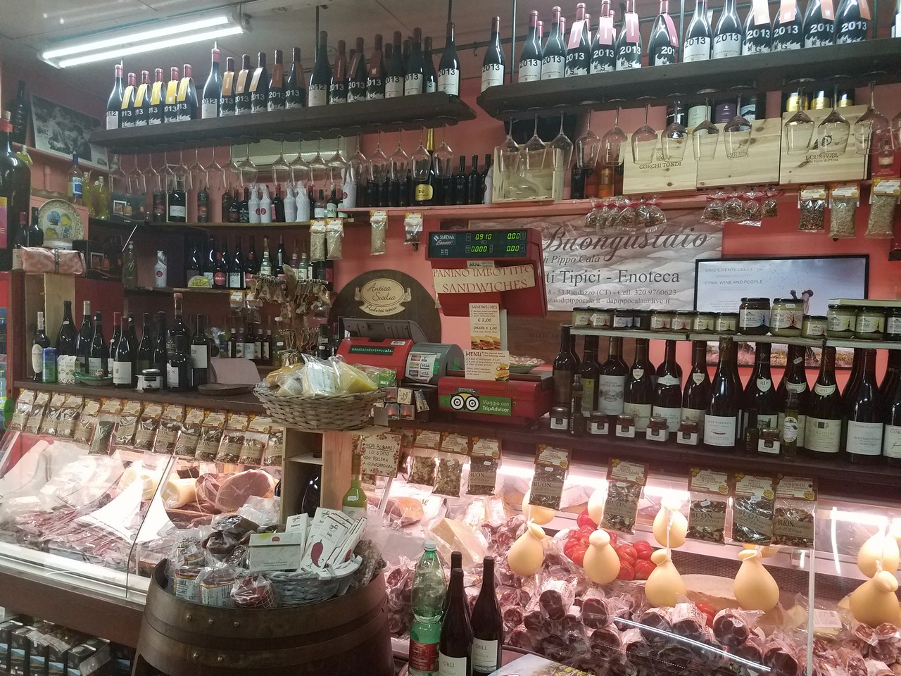 a store with shelves of food and wine bottles