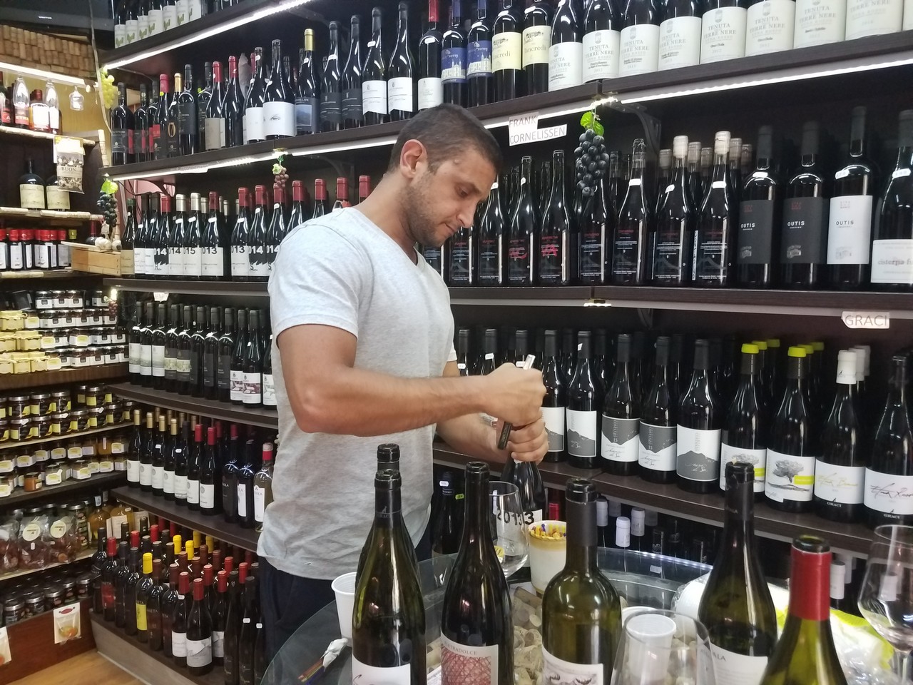 a man opening a bottle of wine