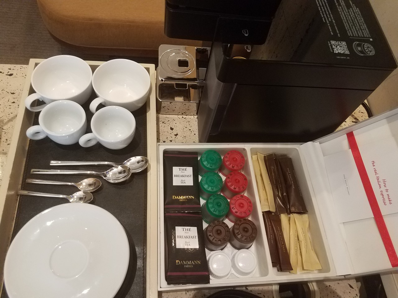 a tray with coffee cups and teapots