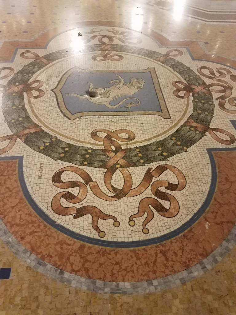 a mosaic floor with a hole in it