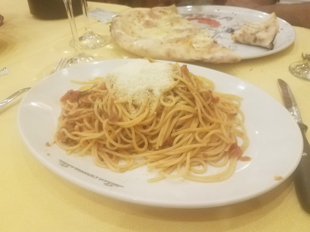 a plate of spaghetti and cheese on a table