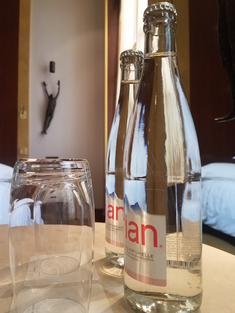 a glass bottle and a glass on a table