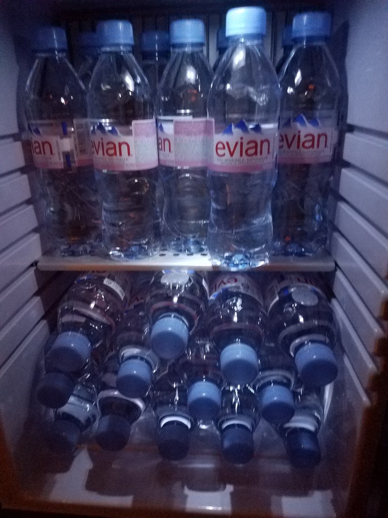 a group of water bottles in a refrigerator