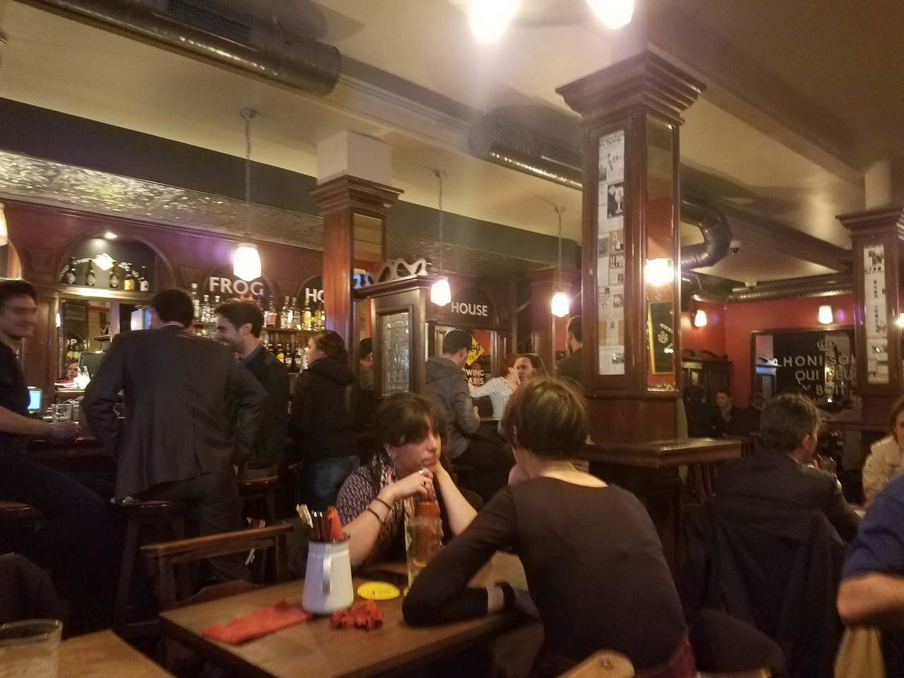 a group of people sitting at a table in a bar