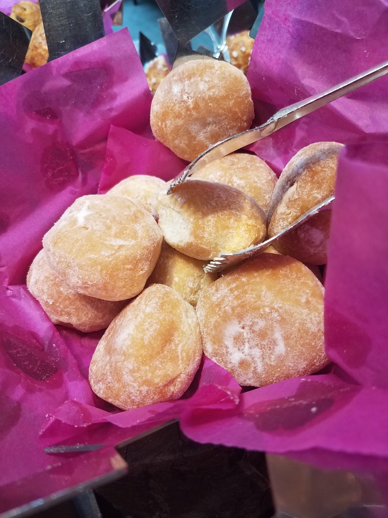 a group of doughnuts in a pink wrapper