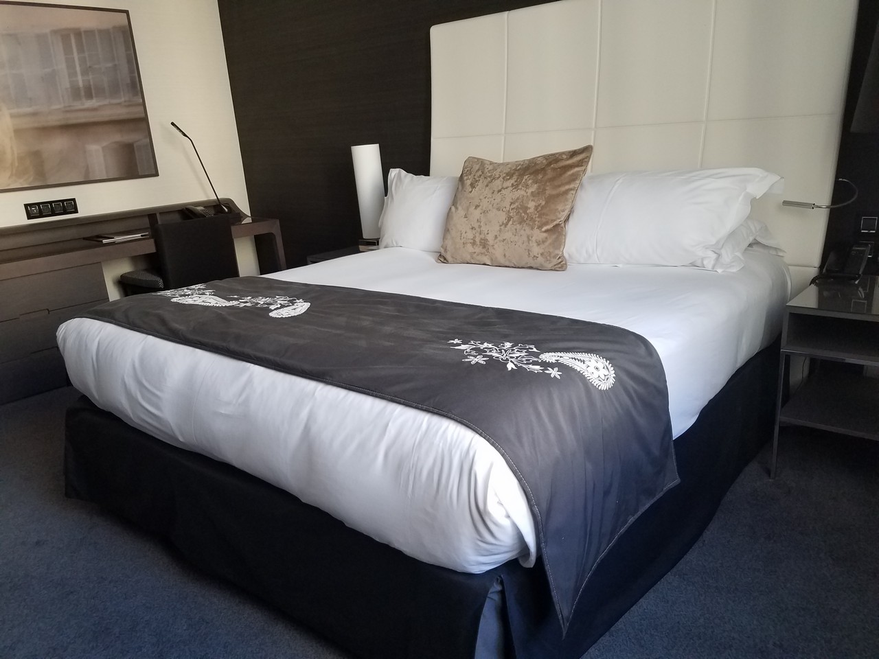 a bed with a black and white blanket