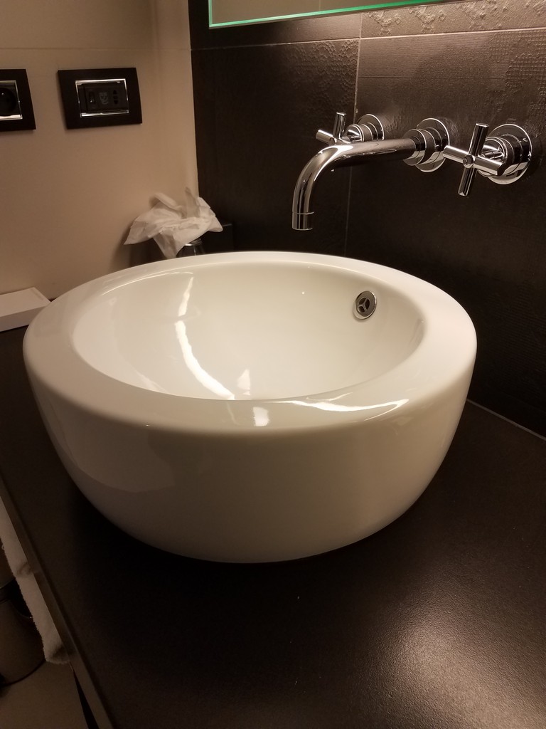 a white sink with faucet