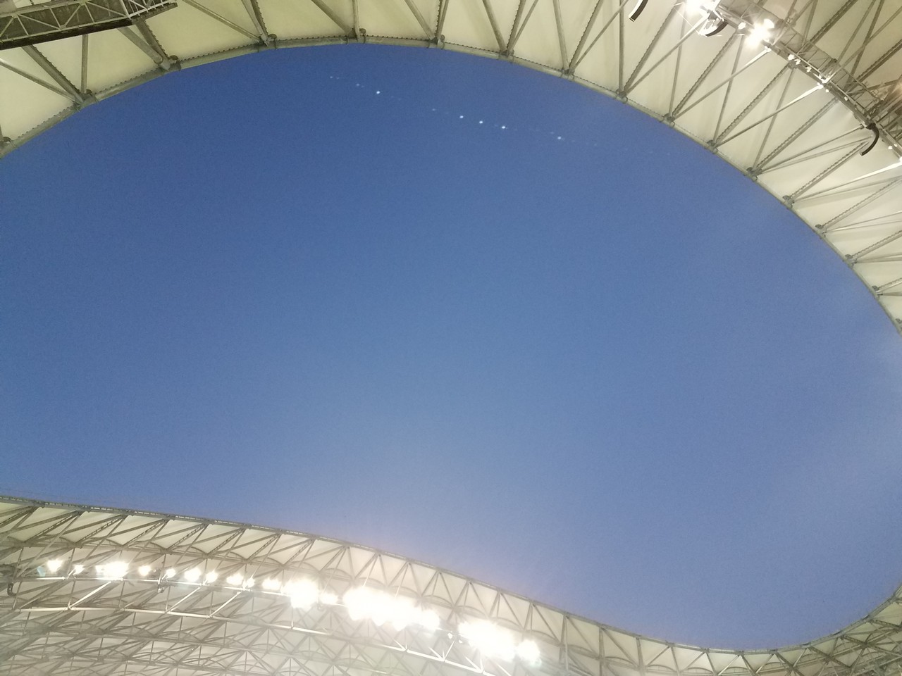 a blue sky above a stadium