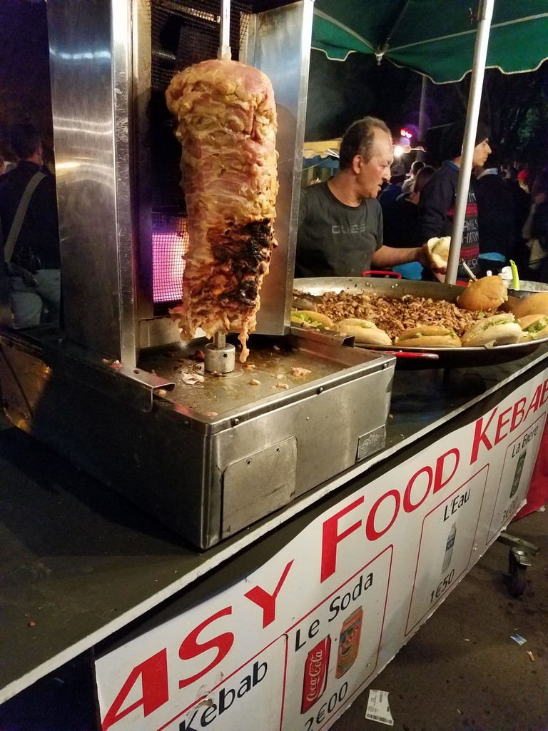 a food stand with a man standing behind it