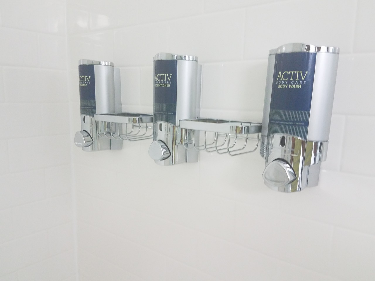 a group of soap dispensers on a wall