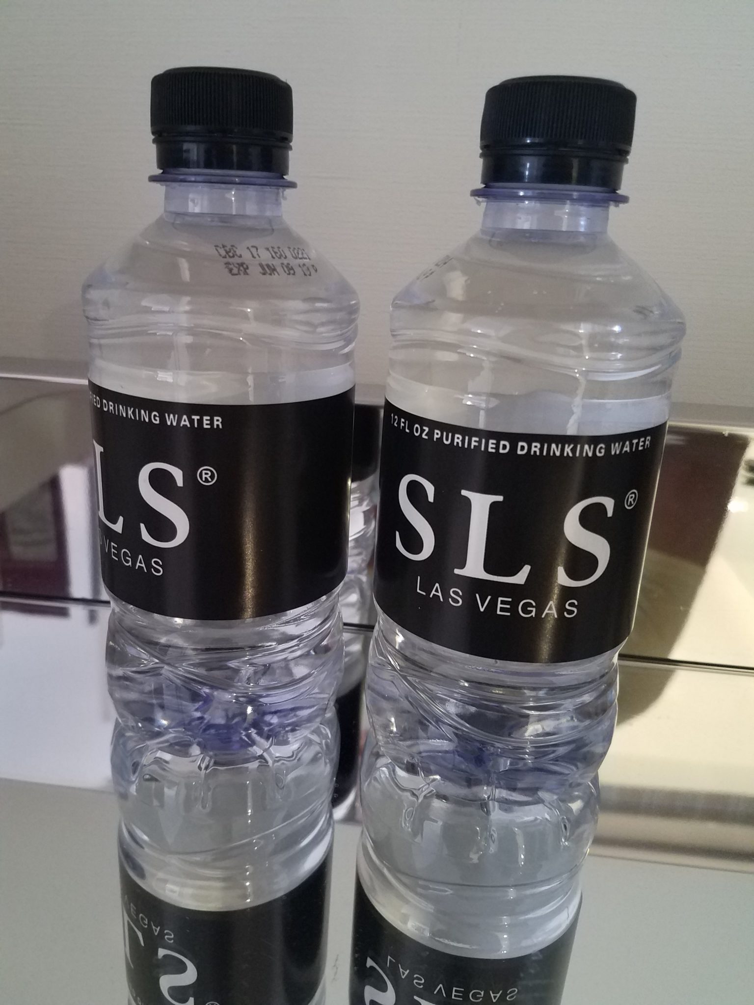 two plastic bottles with black labels