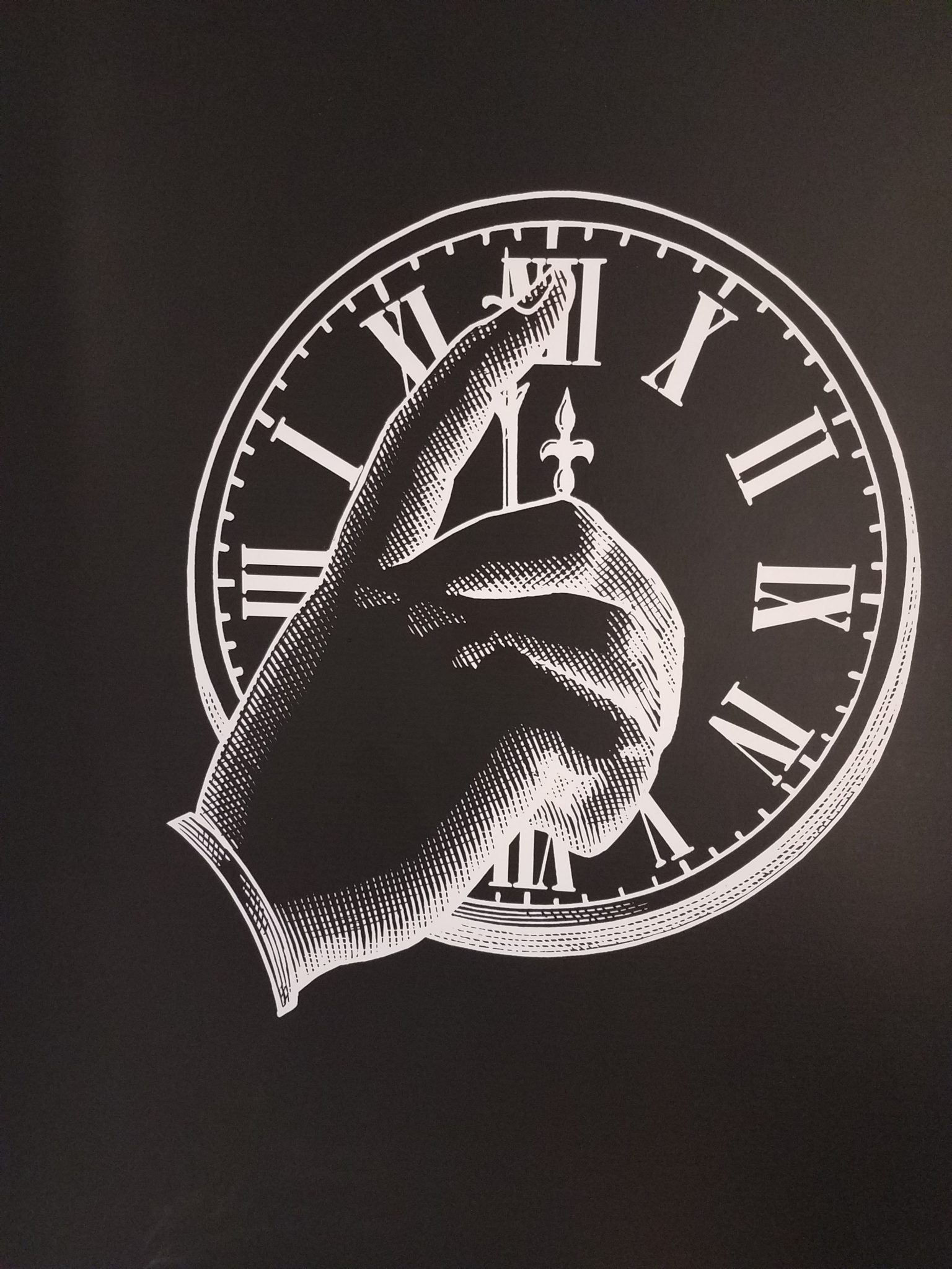 a hand pointing at a clock