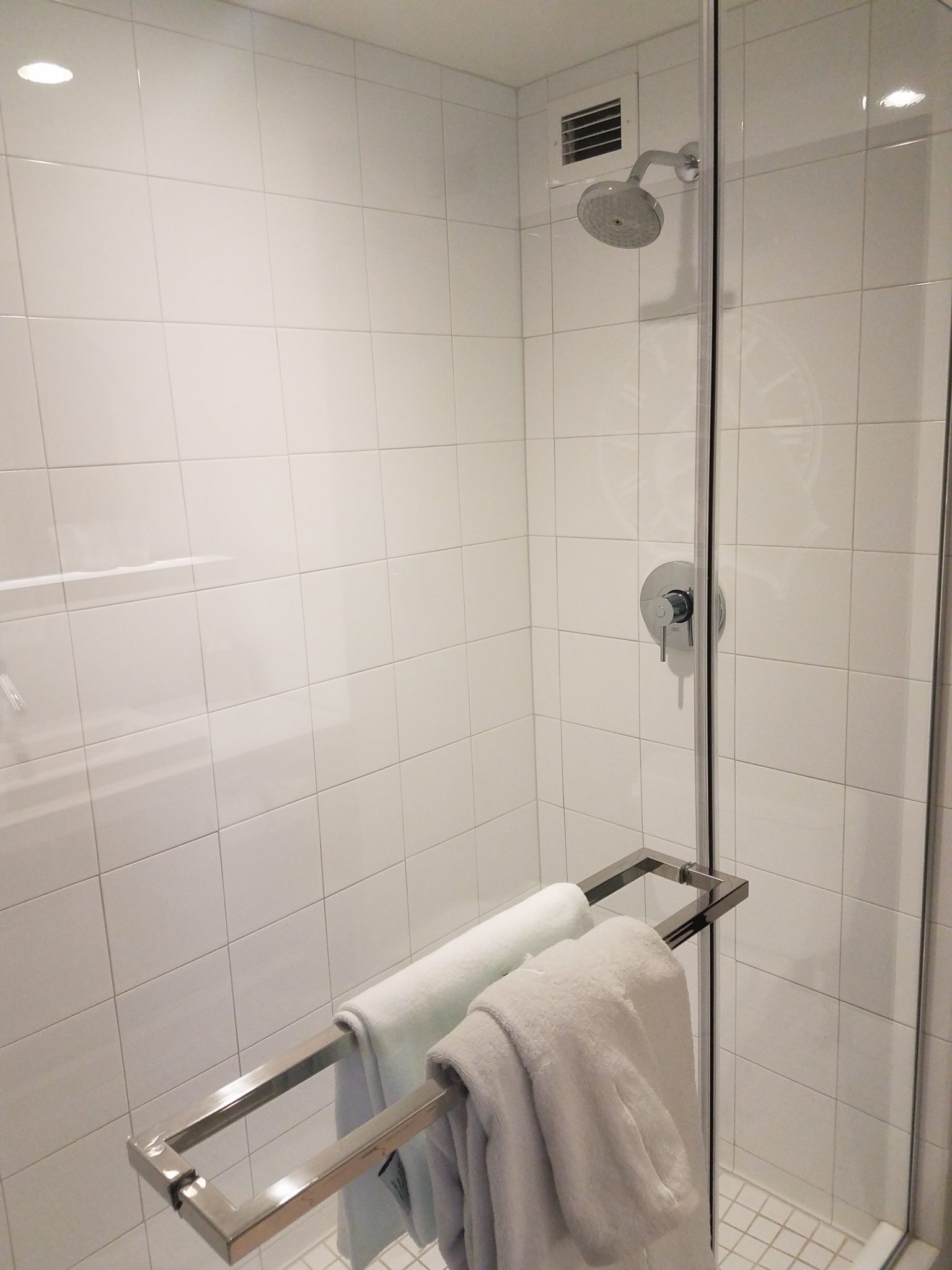 a shower with a towel rack