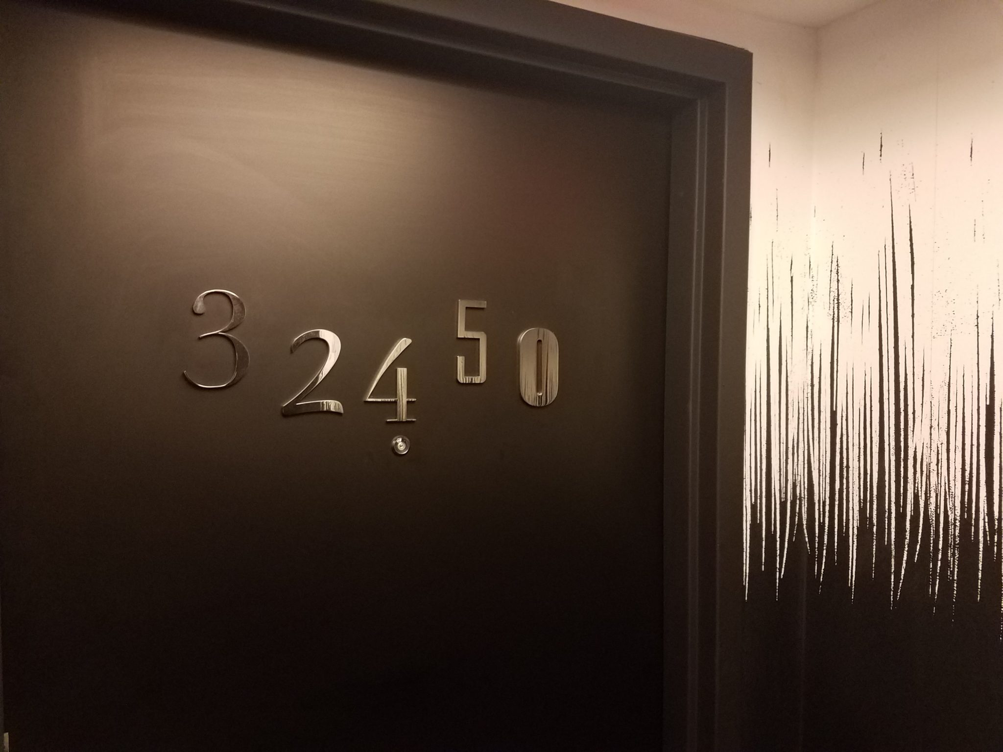 a door with numbers and a white paint splatter