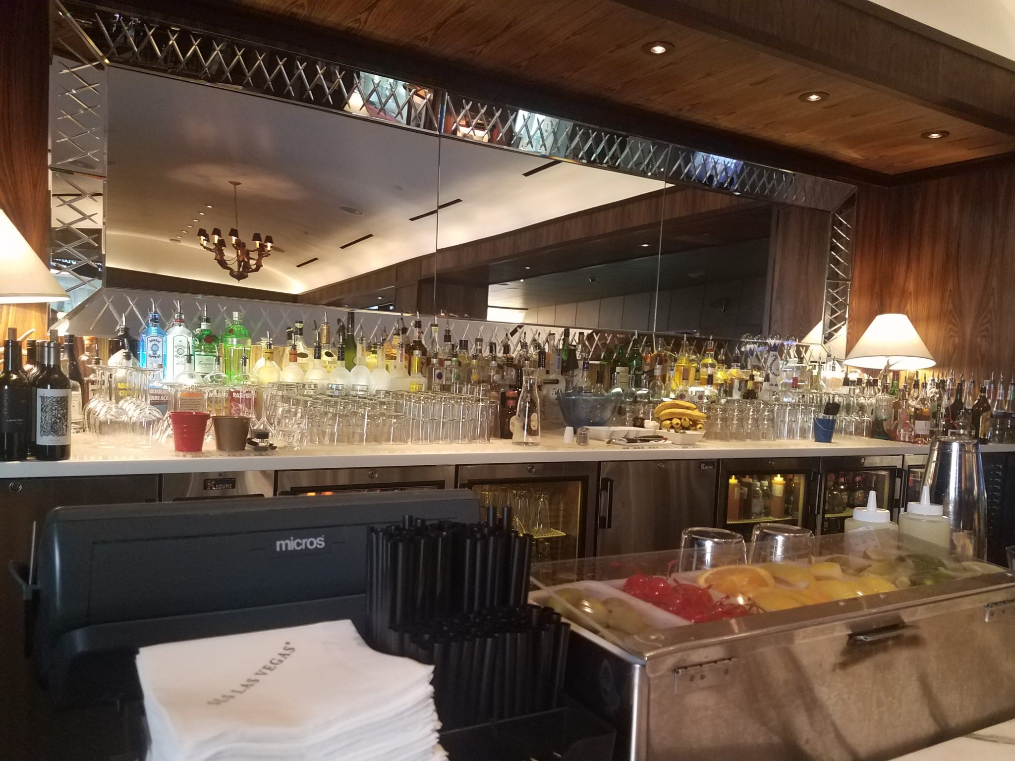 a bar with a large counter full of drinks