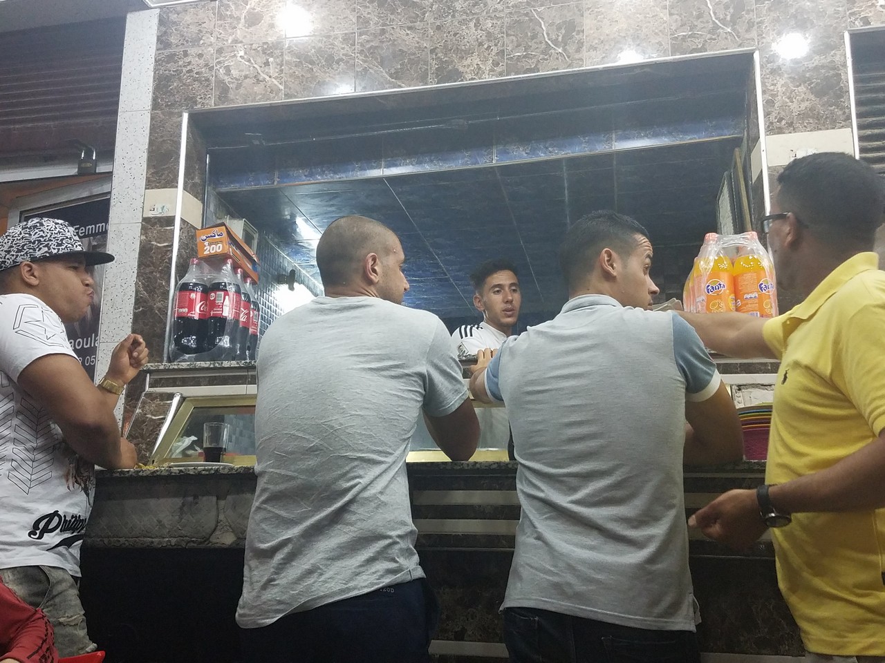 a group of men standing at a counter