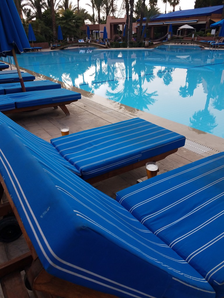 a pool with lounge chairs and umbrellas