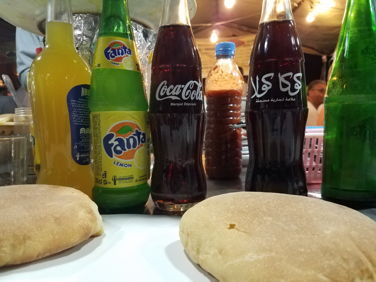 a group of soda bottles and bread on a table
