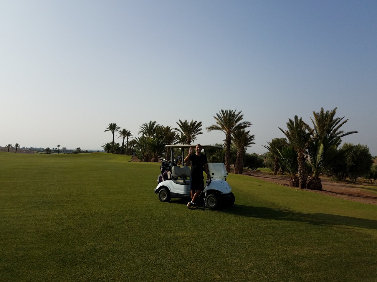 a person standing in a golf cart