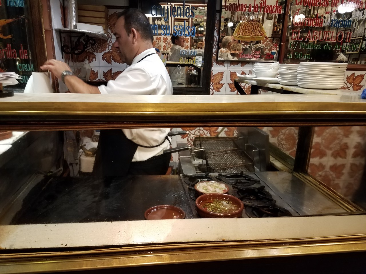 a man cooking food in a restaurant