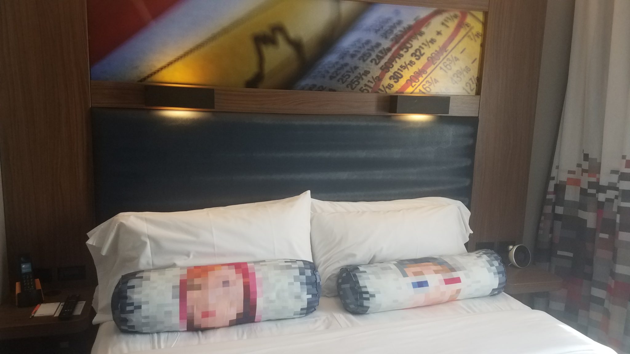 a bed with pillows and a picture of a face on it