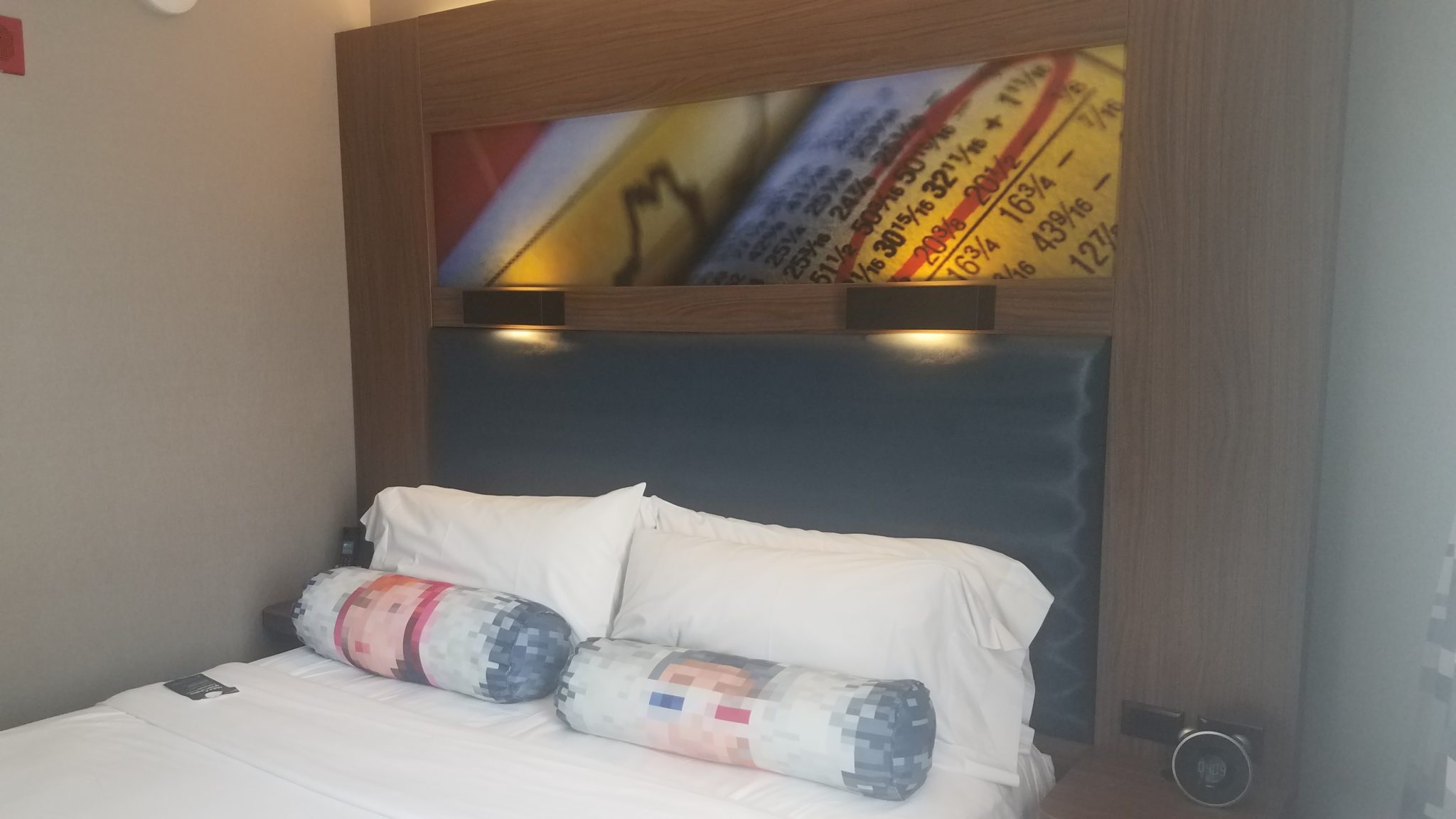 a bed with pillows and a picture of numbers on it