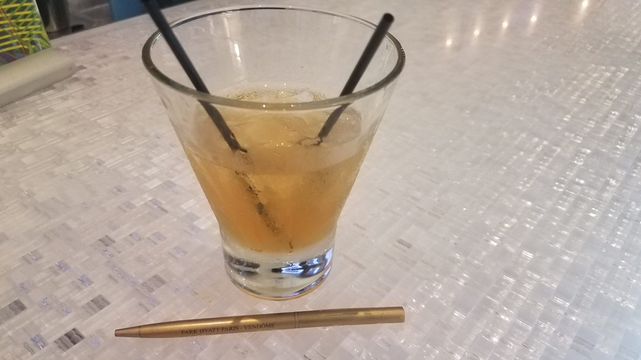 a glass with liquid and straws