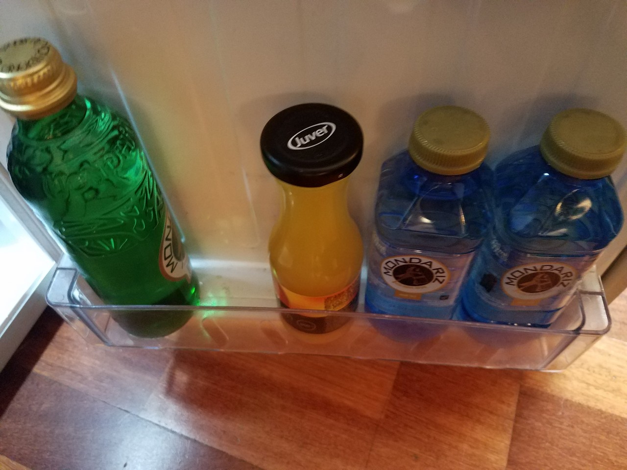 a group of bottles in a clear container