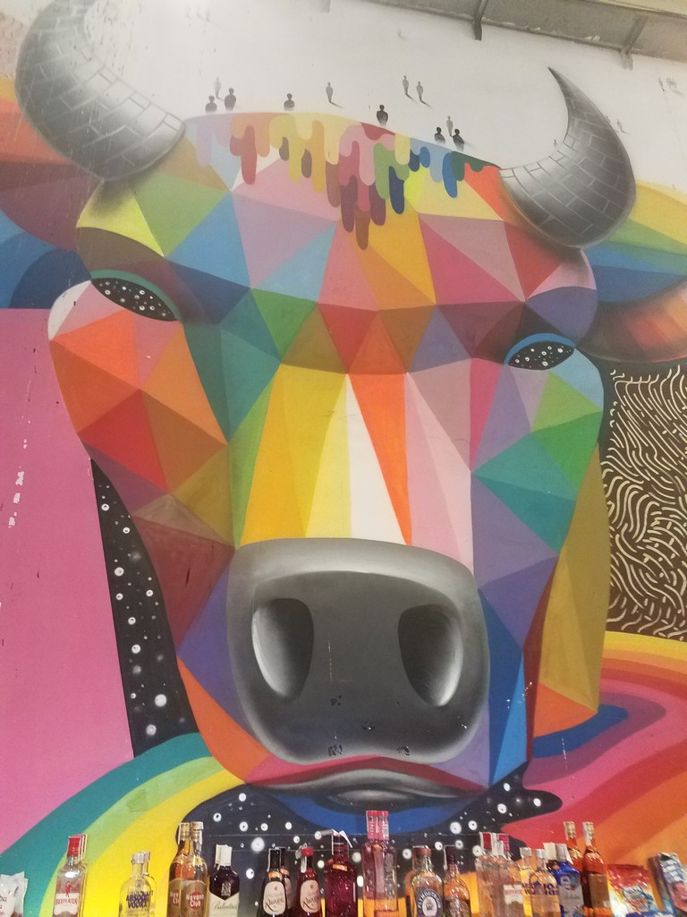 a colorful painting of a cow