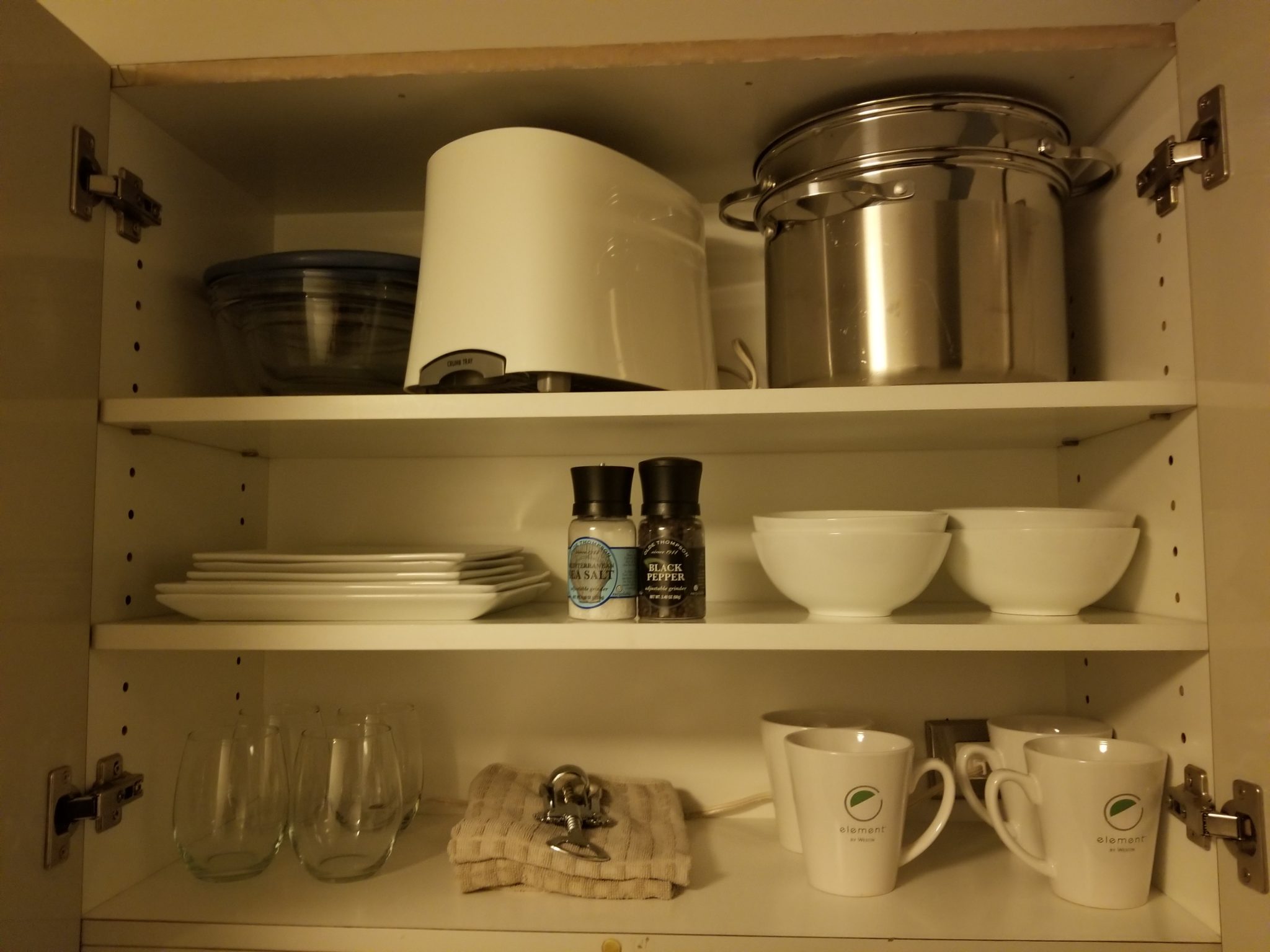 a shelf with white shelves and white utensils