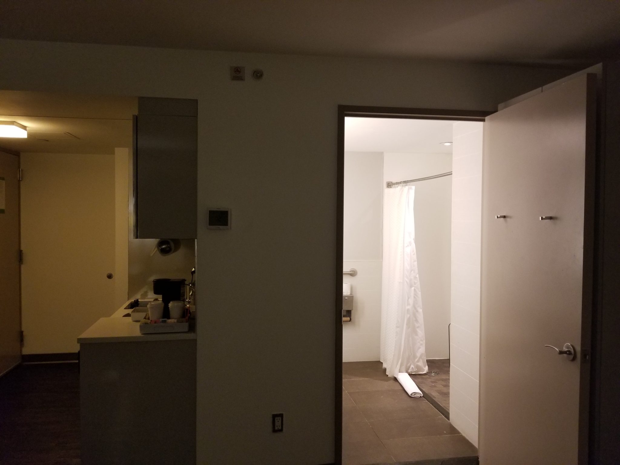 a bathroom with a white curtain and a sink