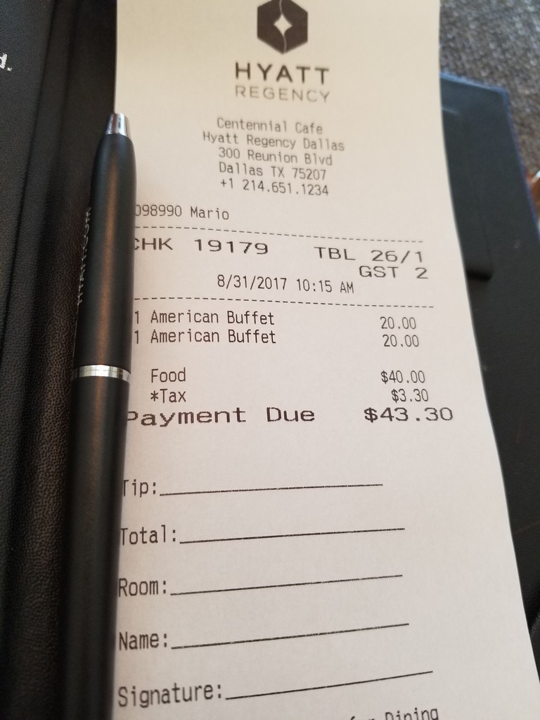 a receipt with a pen on it