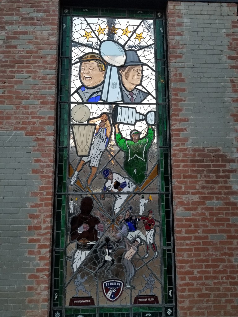 a stained glass window on a brick wall