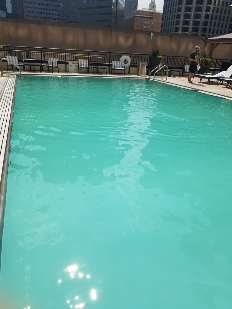 a pool with a person standing next to it