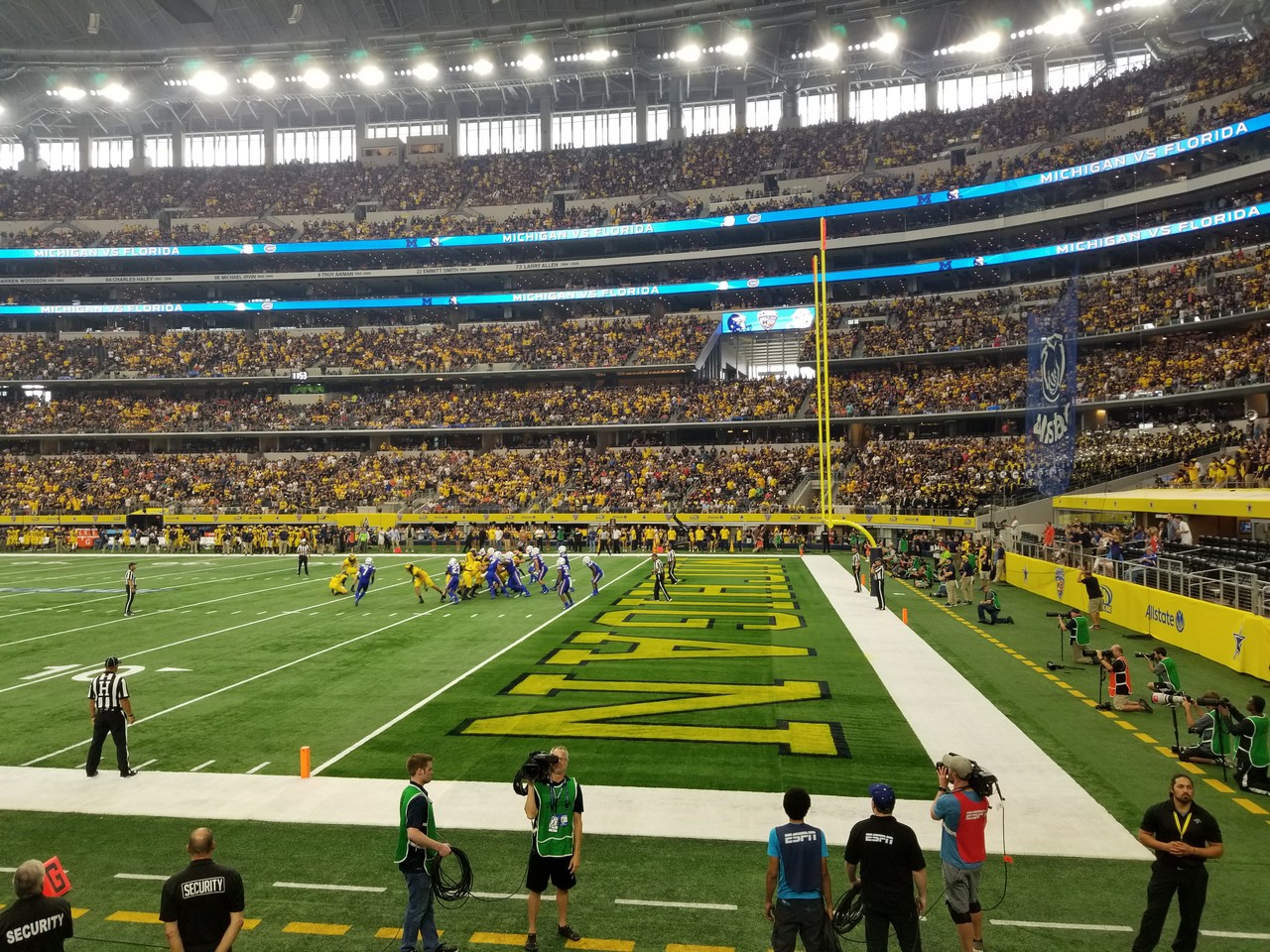 a football stadium with people in the stands with AT&T Stadium in the background
