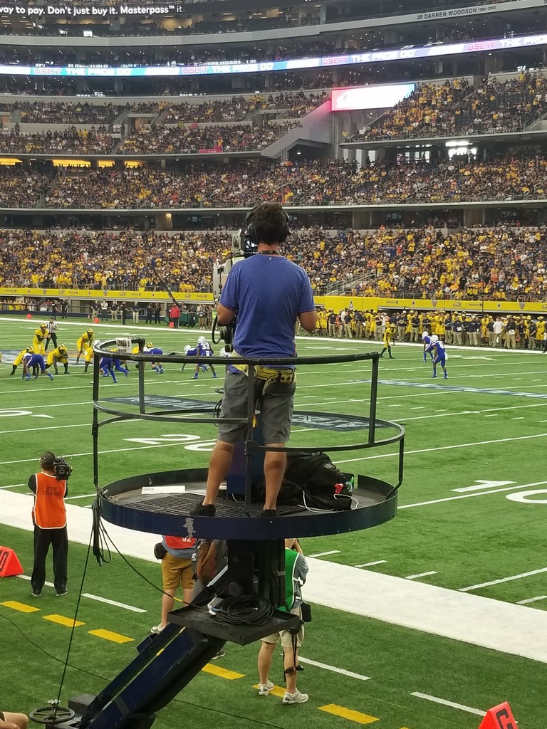 a man standing on a platform in a stadium